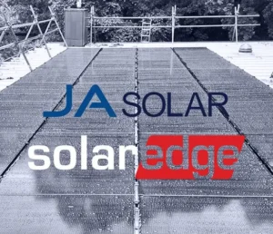 JA Solar & SolarEdge brand logos over solar array on roof