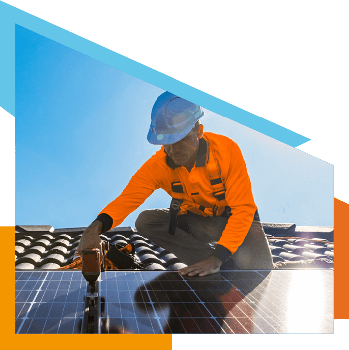 man installing solar panels on a roof