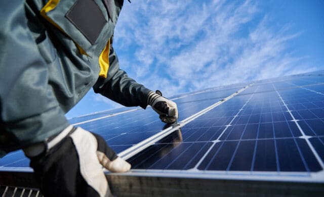 person installing a solar panel