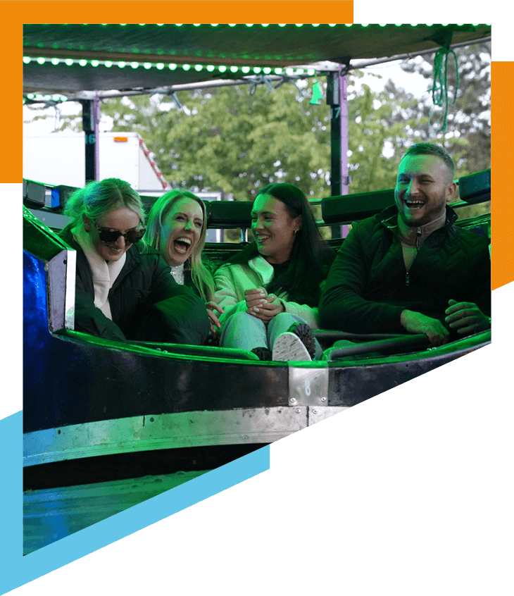 friends laughing on a fairground ride