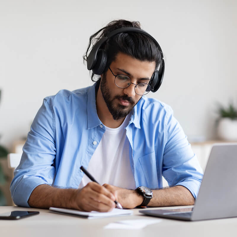 man with headphones and laptop